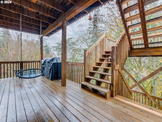 wooden terrace with a grill