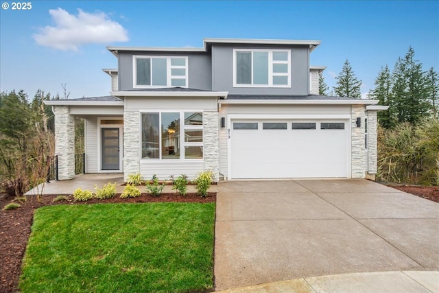 prairie-style home with a garage, stone siding, a front lawn, and driveway