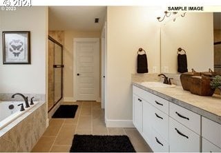 bathroom featuring plus walk in shower, tile patterned flooring, and vanity