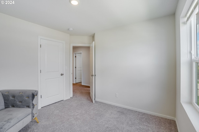 unfurnished room with light colored carpet