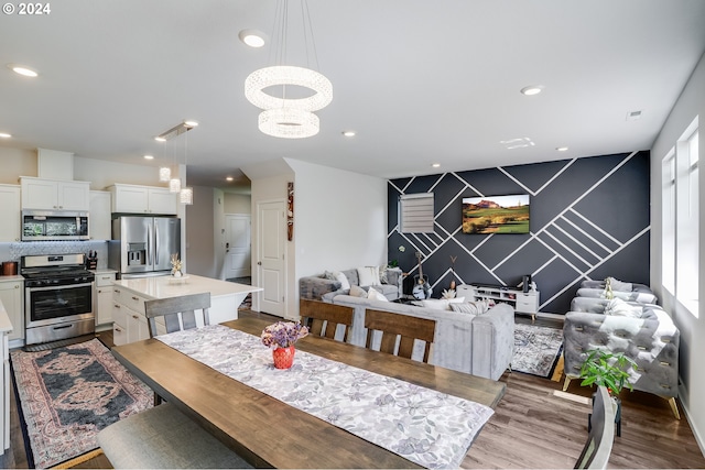 dining space with wood-type flooring