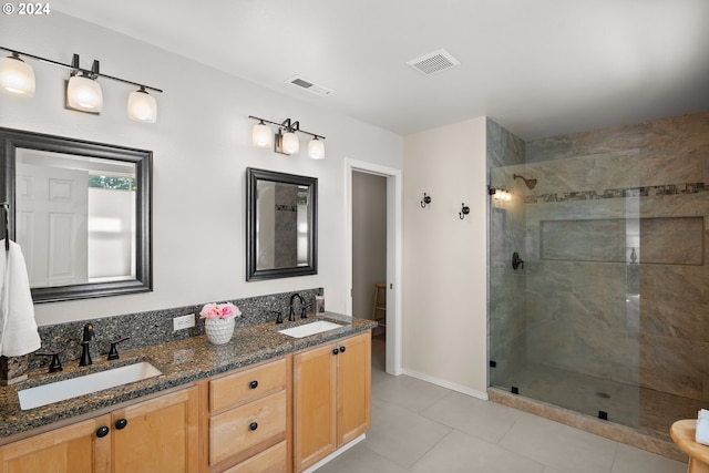 bathroom featuring a tile shower, tile patterned flooring, vanity, and toilet