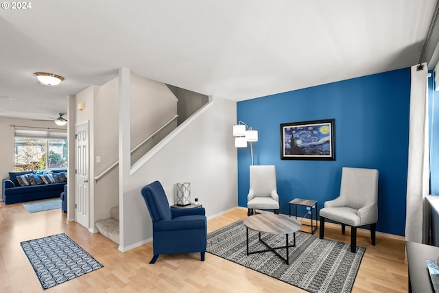 sitting room featuring ceiling fan and hardwood / wood-style floors