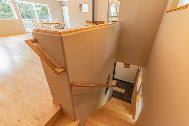 stairs featuring hardwood / wood-style floors