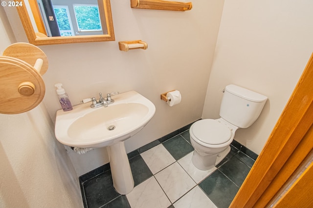 bathroom featuring tile patterned flooring and toilet