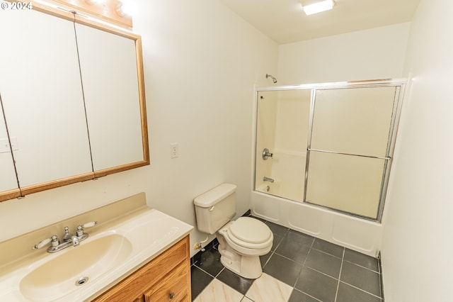 full bathroom featuring shower / bath combination with glass door, vanity, toilet, and tile patterned floors