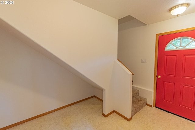 foyer featuring light carpet