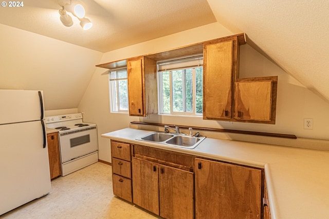 kitchen with white appliances, a textured ceiling, vaulted ceiling, and sink