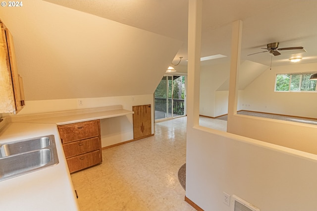 bonus room featuring lofted ceiling, ceiling fan, and sink