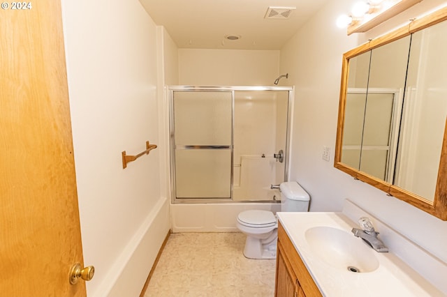 full bathroom featuring shower / bath combination with glass door, vanity, and toilet