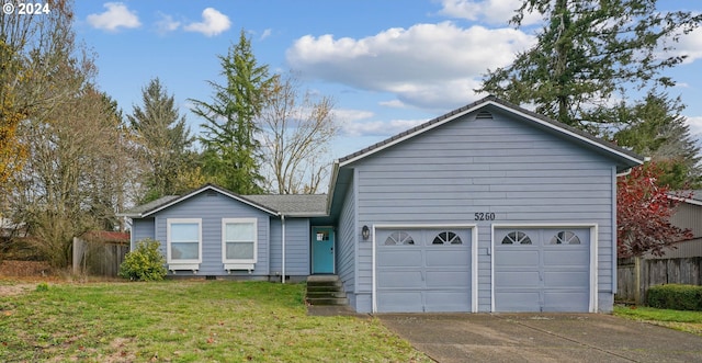 view of front of home with a garage and a front lawn