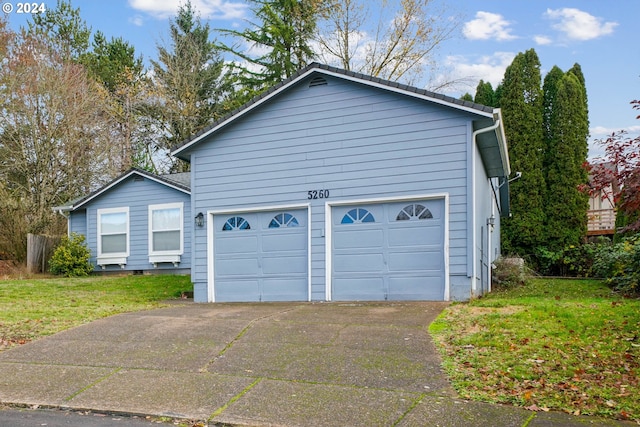 view of home's exterior featuring a yard and a garage