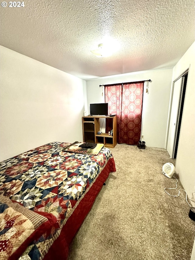 carpeted bedroom with a textured ceiling