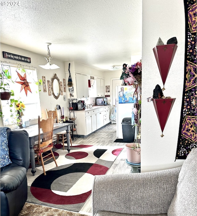 carpeted living room featuring a textured ceiling