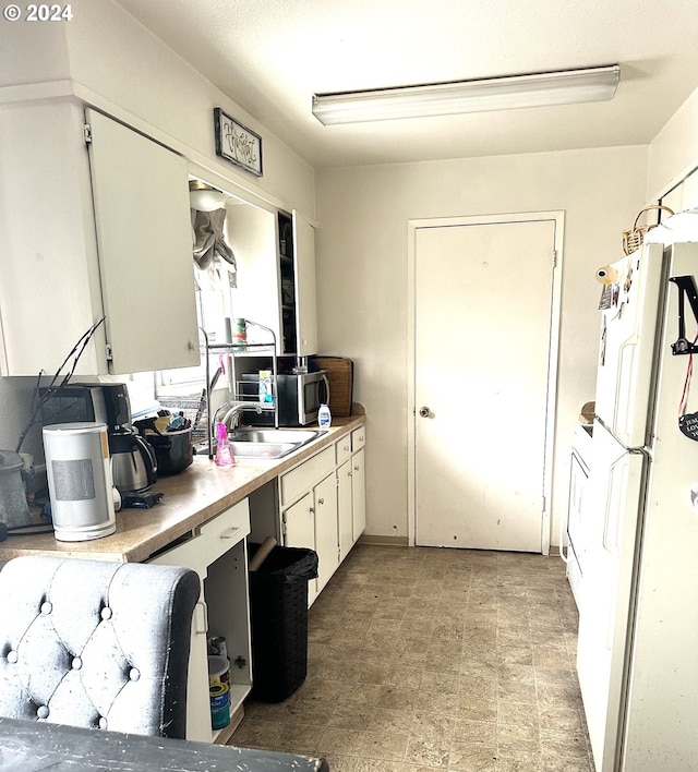 kitchen with sink, white cabinetry, and light tile floors