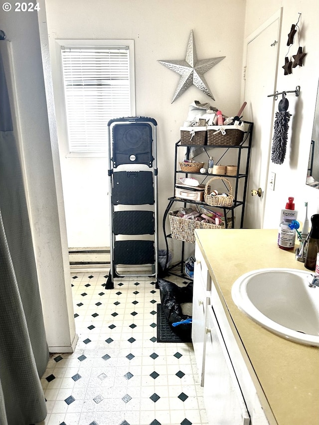 bathroom with tile floors and vanity