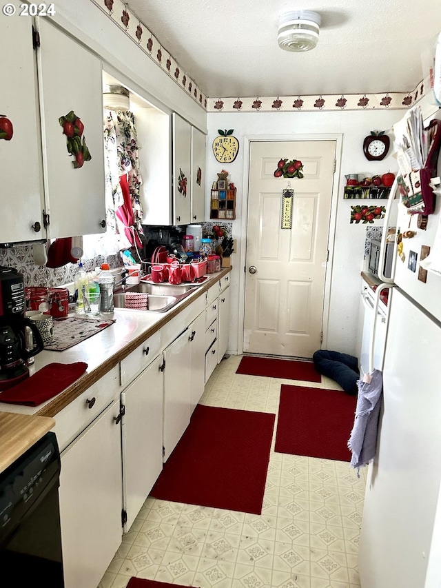 kitchen with sink, white cabinetry, dishwasher, and light tile flooring