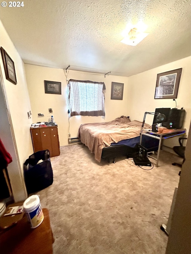 bedroom with light carpet and a textured ceiling