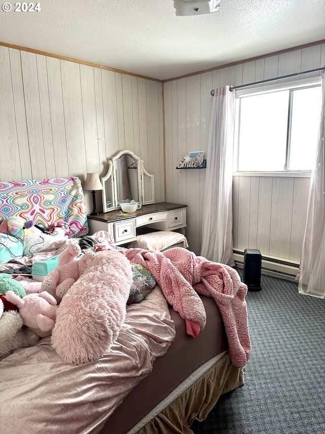 carpeted bedroom featuring wooden walls, a textured ceiling, and a baseboard radiator