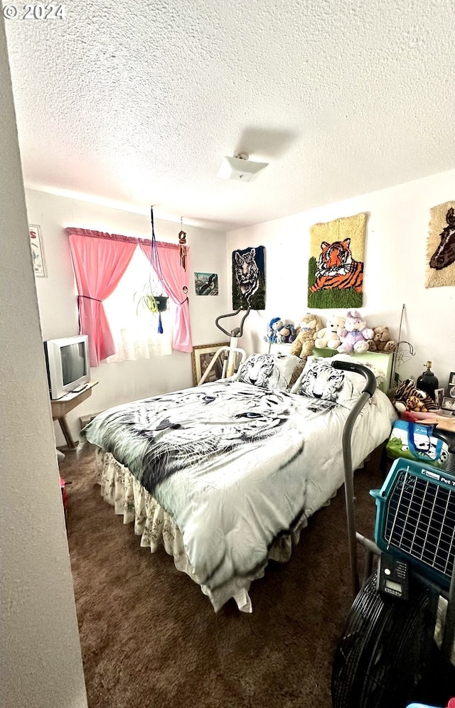 carpeted bedroom with a textured ceiling