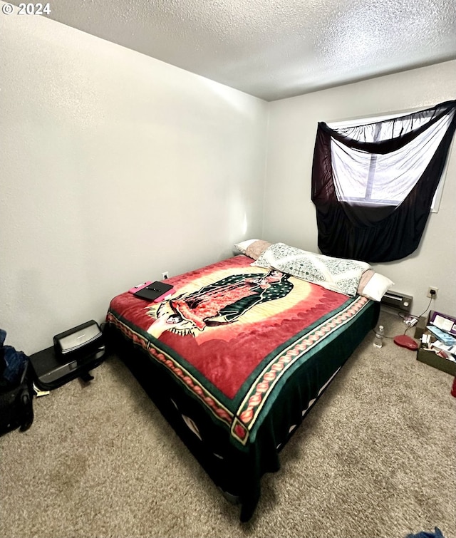 carpeted bedroom with a textured ceiling