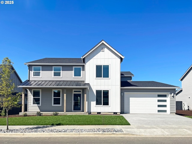 16910 NE 38th Ave, Vancouver, WA 98686 - modern inspired farmhouse featuring concrete driveway, a front lawn, an attached garage, metal roof, and a standing seam roof