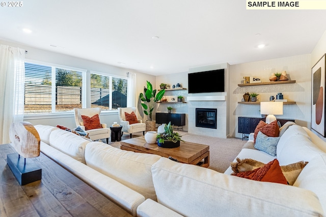 carpeted living room with a tiled fireplace