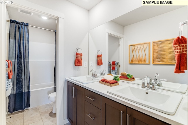 full bathroom with tile patterned floors, vanity, toilet, and shower / bath combo