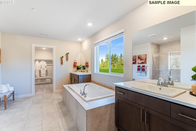 bathroom with separate shower and tub, tile patterned flooring, and vanity