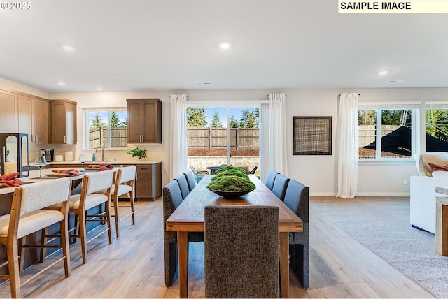 dining space featuring sink and light hardwood / wood-style floors