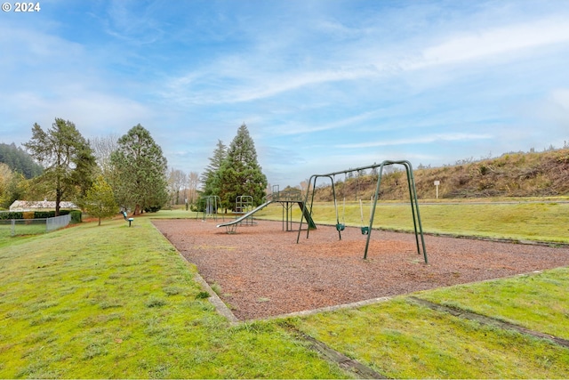 view of playground with a lawn