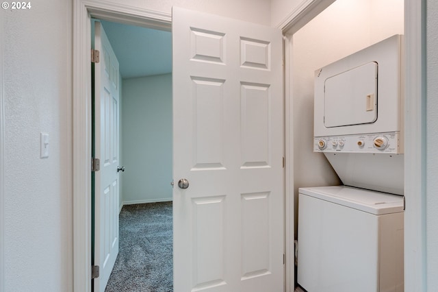 clothes washing area featuring carpet and stacked washer and clothes dryer