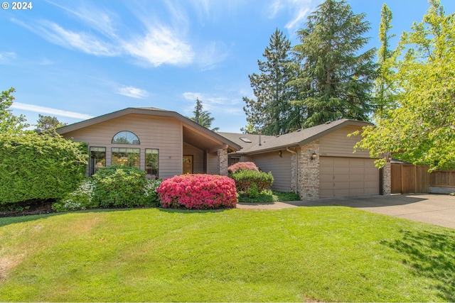 single story home with a front yard and a garage