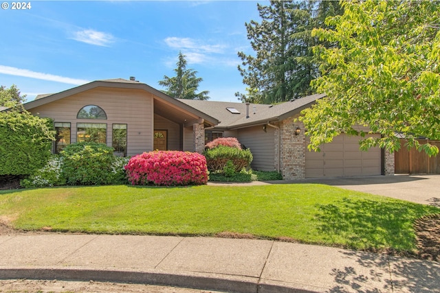 ranch-style home with a garage and a front lawn