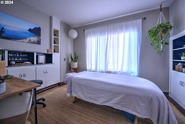 bedroom with hardwood / wood-style flooring