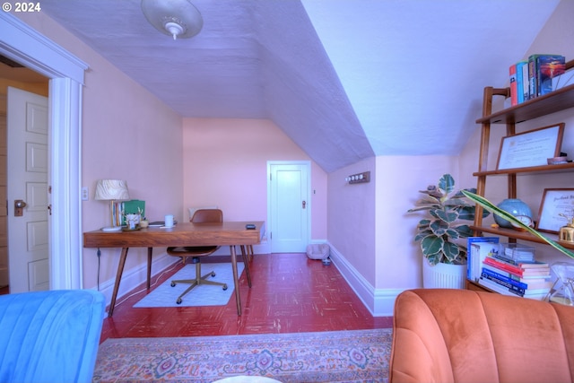 home office featuring vaulted ceiling and dark parquet floors