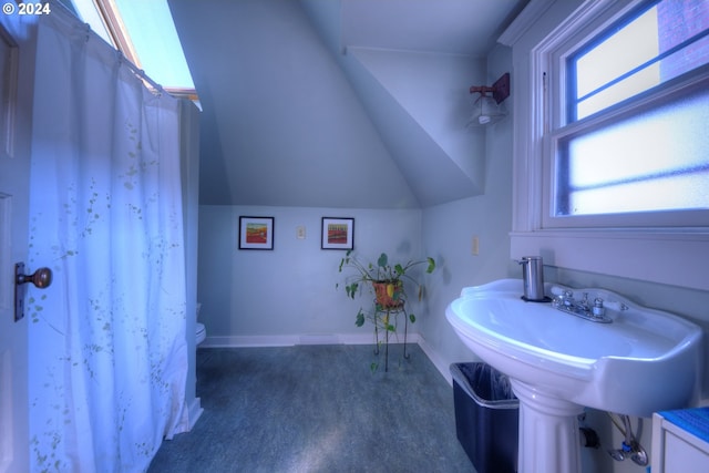 bathroom with vaulted ceiling and toilet