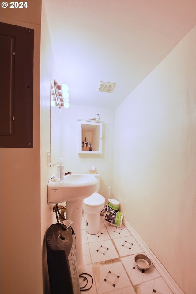 bathroom featuring toilet and electric panel