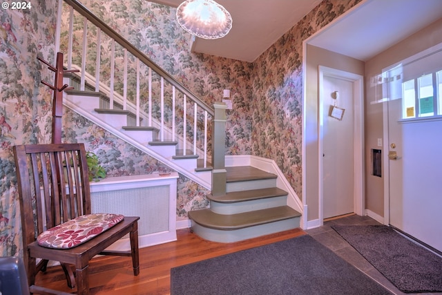 foyer with hardwood / wood-style flooring and radiator heating unit