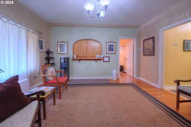 living area with a chandelier and light hardwood / wood-style flooring