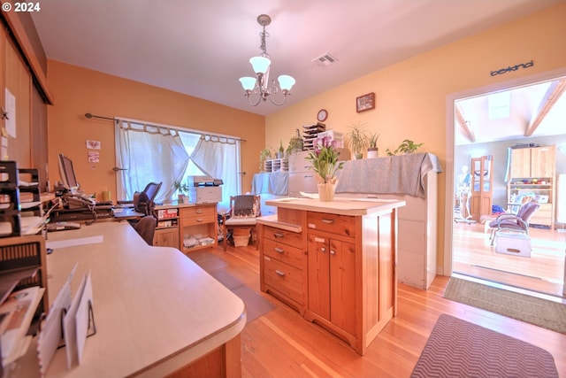 home office with a notable chandelier and light hardwood / wood-style floors