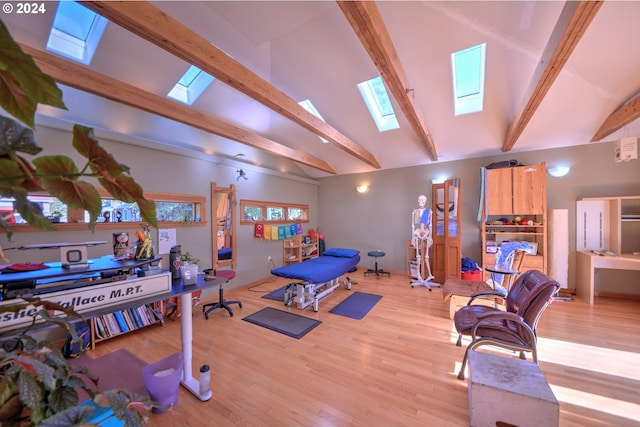 workout area featuring vaulted ceiling and light hardwood / wood-style floors