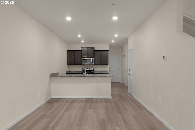 59 NE 134th Pl, Portland, OR 97230 - kitchen with appliances with stainless steel finishes, recessed lighting, light wood finished floors, baseboards, and a peninsula