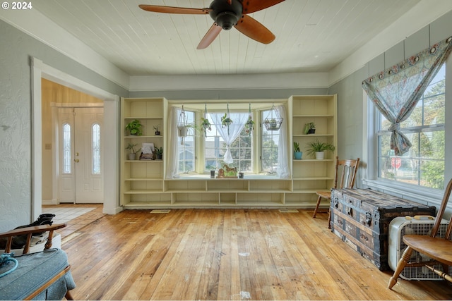 entryway featuring ceiling fan, a wealth of natural light, wood ceiling, and light hardwood / wood-style flooring