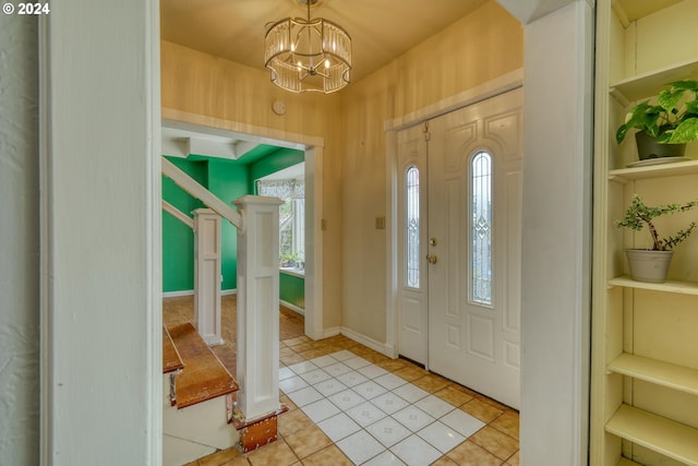 tiled foyer entrance featuring a chandelier