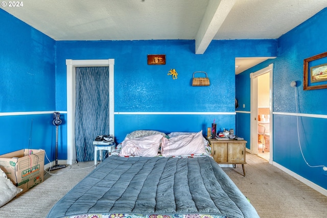 carpeted bedroom featuring a textured ceiling and beam ceiling