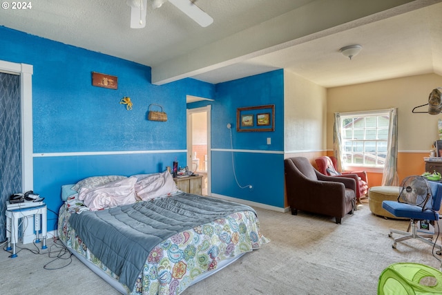 bedroom with beamed ceiling, a textured ceiling, ceiling fan, and carpet