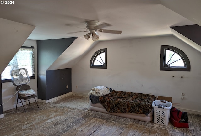 additional living space with ceiling fan, hardwood / wood-style flooring, and vaulted ceiling