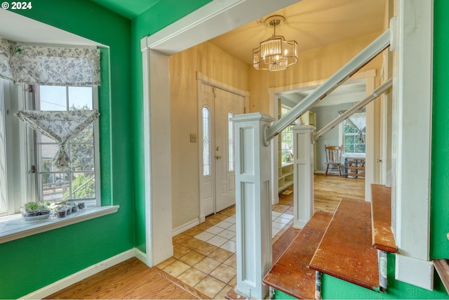 entryway featuring a chandelier and light hardwood / wood-style floors