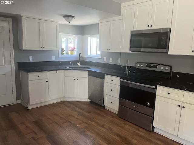 kitchen featuring sink, appliances with stainless steel finishes, dark hardwood / wood-style floors, and white cabinets